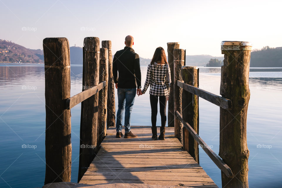 Young couple on wooden jetty while holding hand