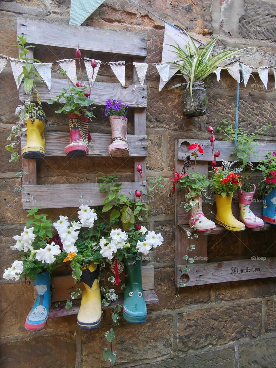Original wall decor with flowers in colorful boots.