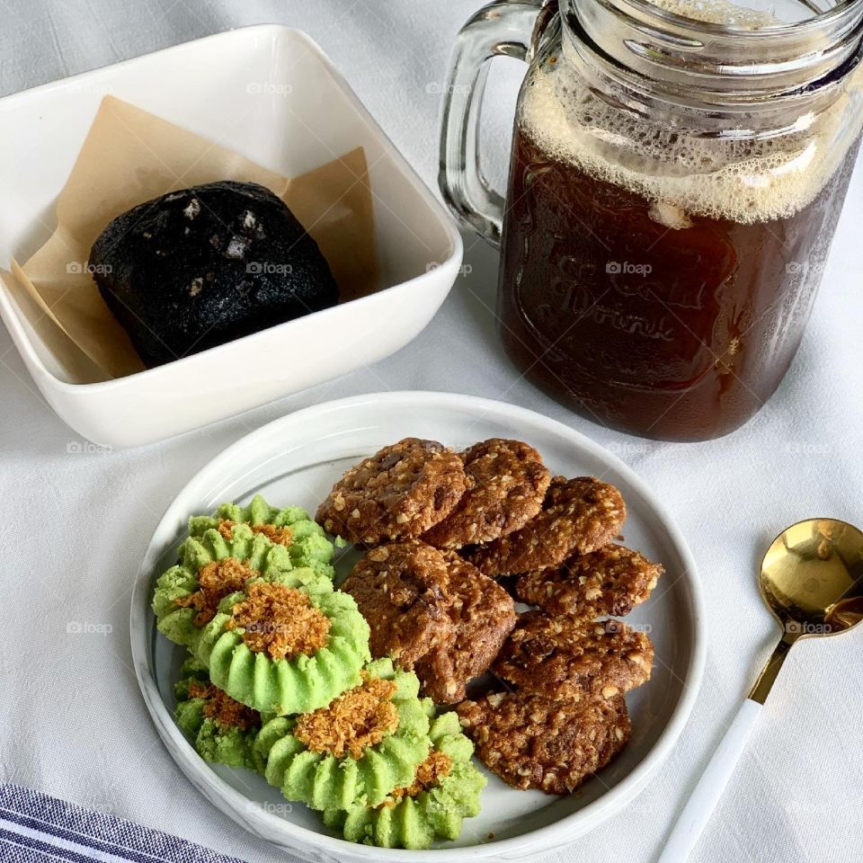 Afternoon snacks ondeh cookies and chocolate chip oat cookies with black brownie and sea salt and ice cold black coffee