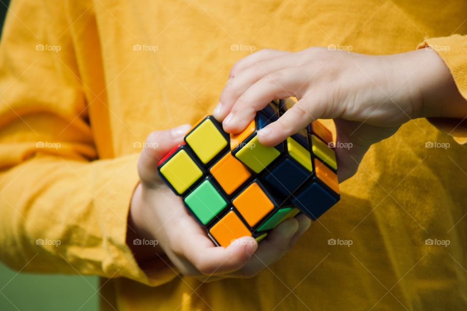 Child playing with the Rubik’s cube 