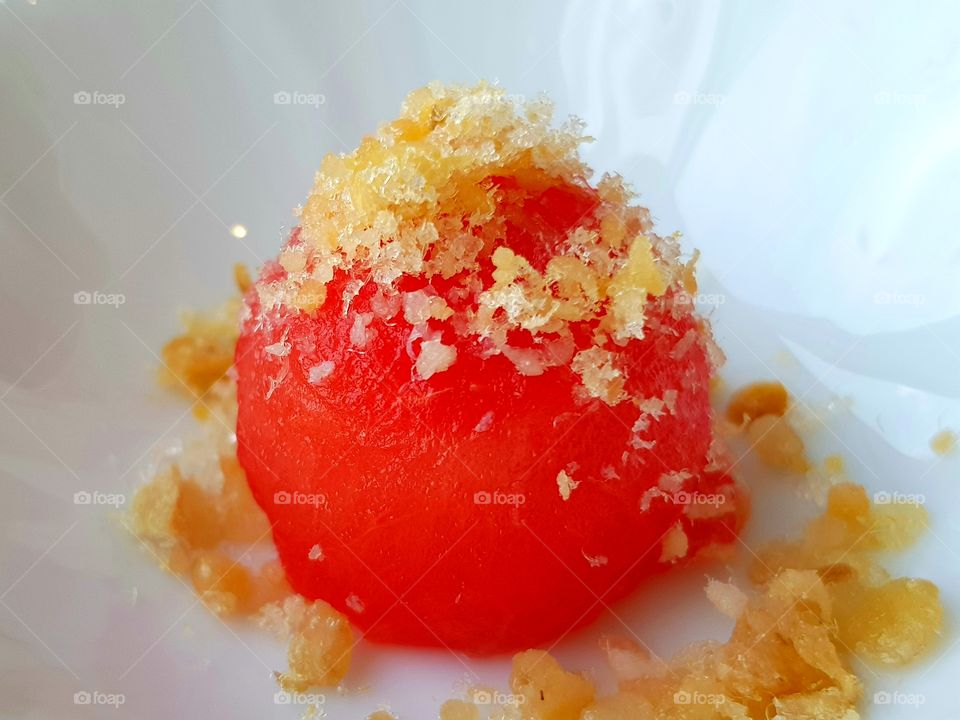 A scoop of melon with crispy dried fish