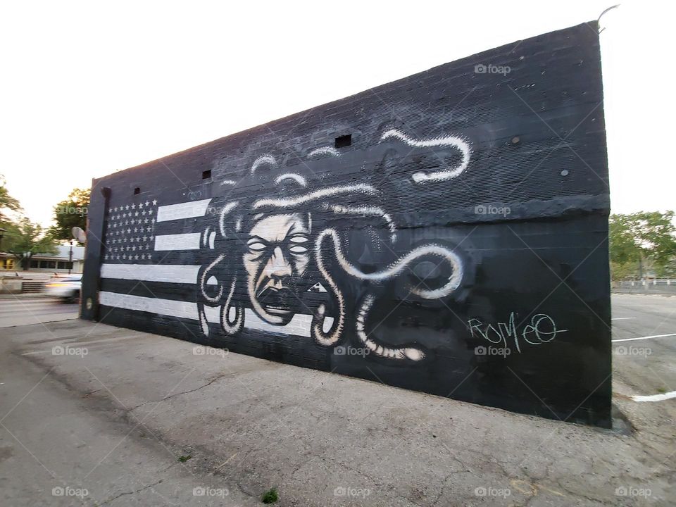 Street art - Medusa and U.S.A flag in black and white.