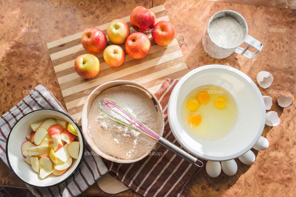 Making homemade puffed apple pie with eggs, sugar and flour.