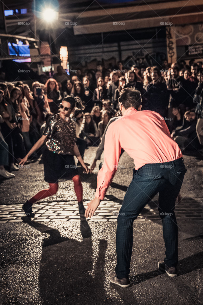 Street Dancing In The Night With Crowd Of People Watching
