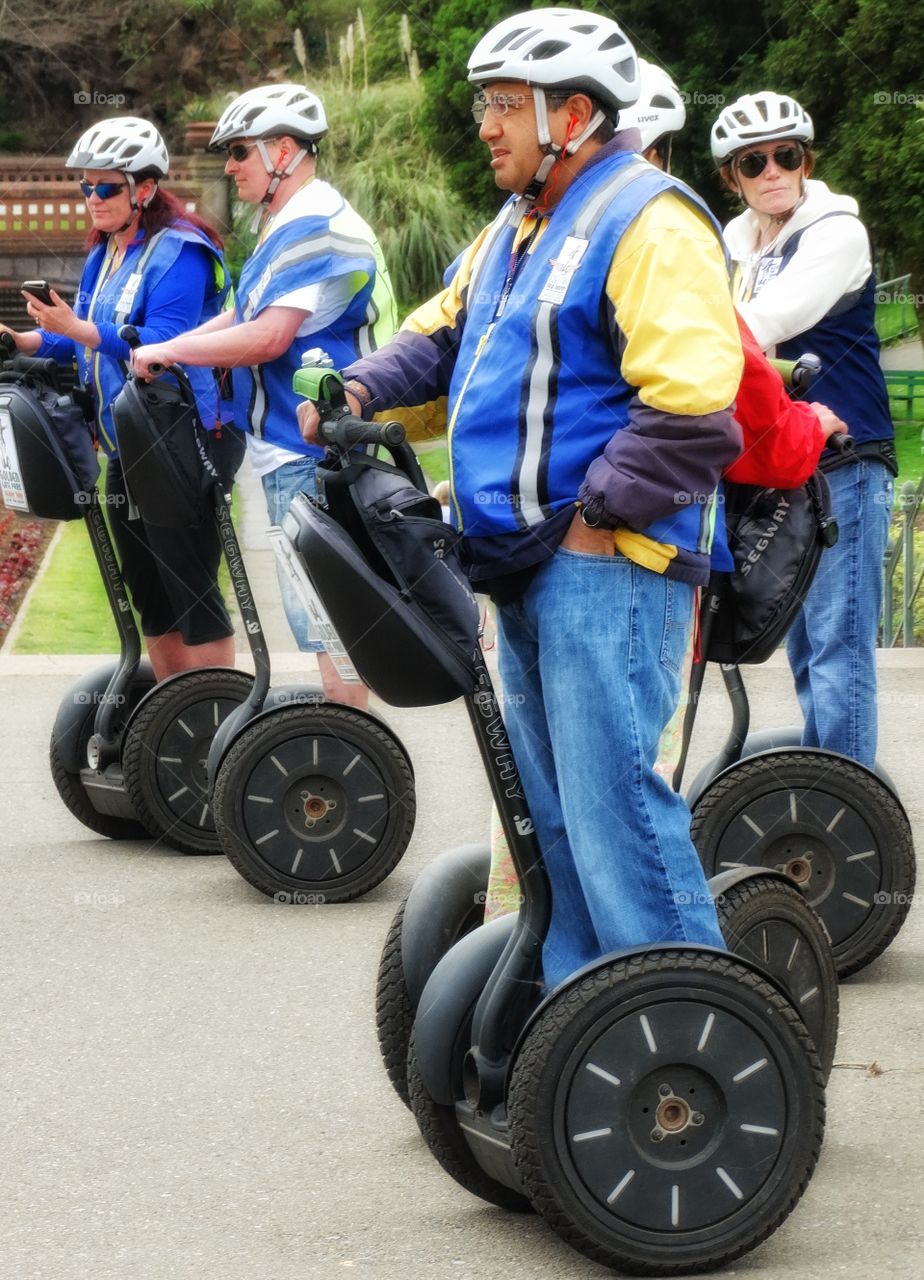 Riding A Segway. Tourists Riding The Segway Transportation System