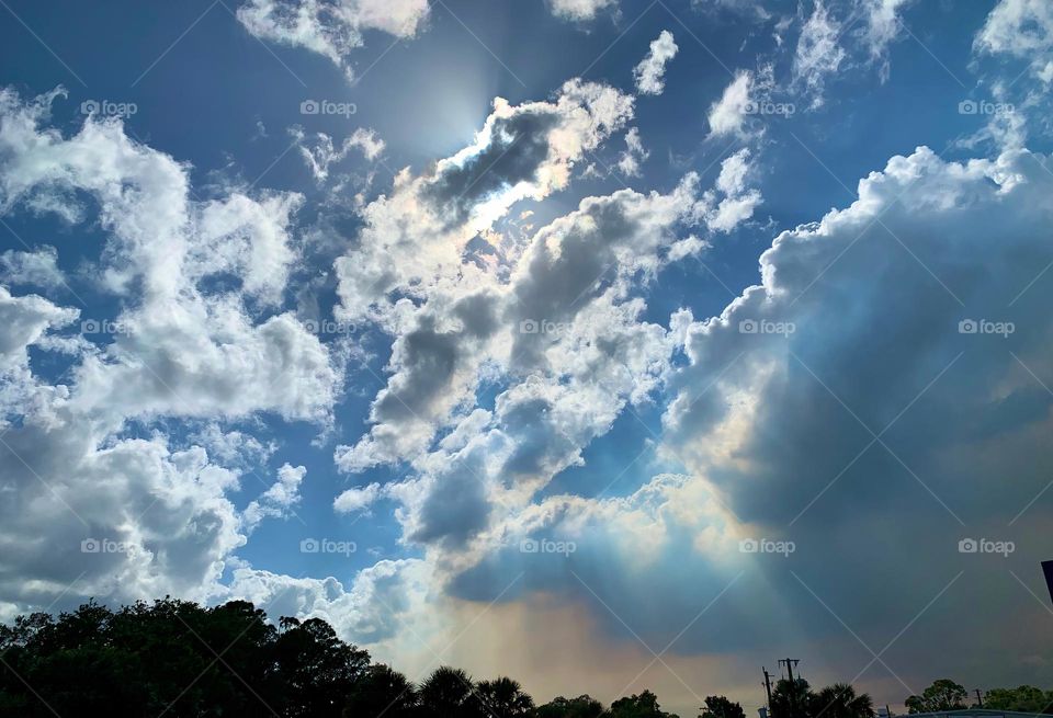 Fire Clouds Noticed Behind The Forest Trees That Created Suspicions Of Possible Danger And Destruction With Spread And Unusual Clouds Formation Of Orange, Grey And Dark Color. Sun Rays Going Through Stratocumulus Clouds. 