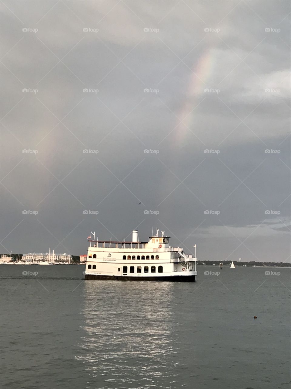 Dinner cruise in the harbor at sunset with rainbow over the water