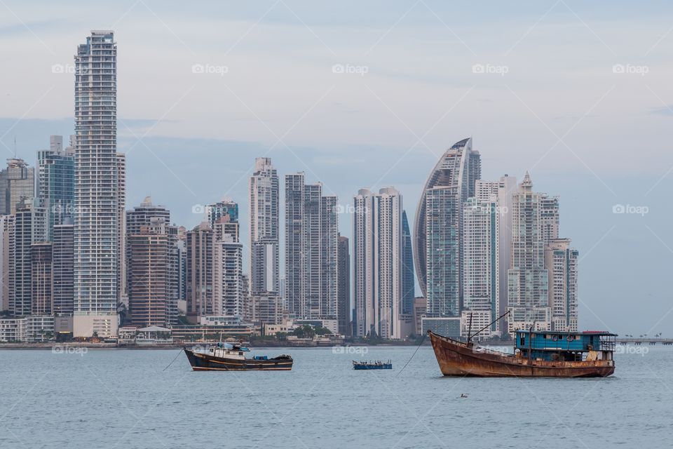 Evening photo of Panama city. Evening photo of Panama City business center. Two fishing boats in the front