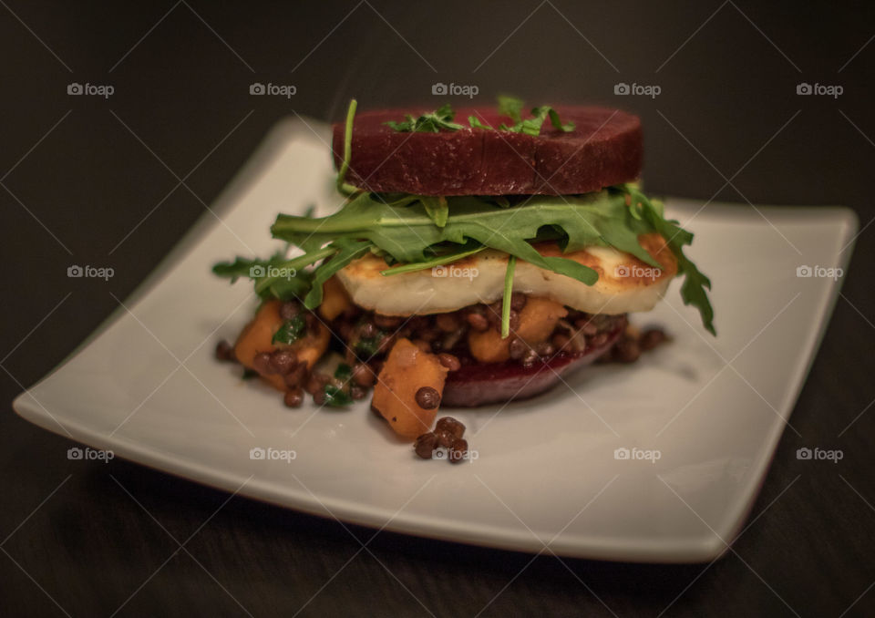 Beetroot burger with halloumi and lentils and arugula 