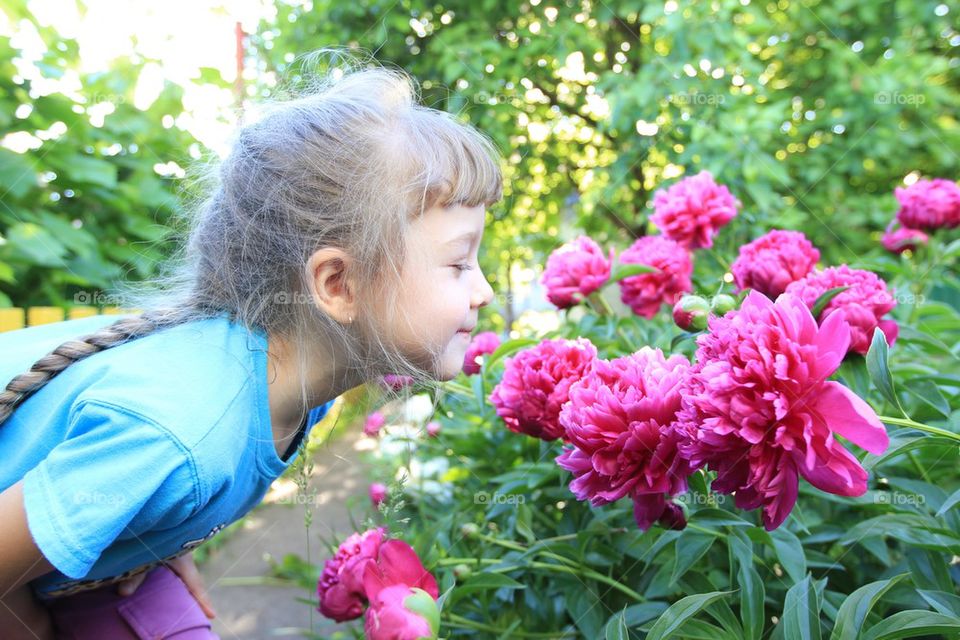 Girl and beautiful pink flowers