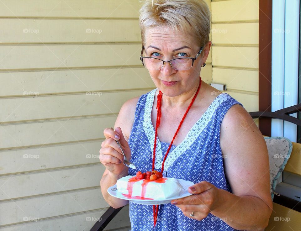 blonde woman eating ice cream with strawberries