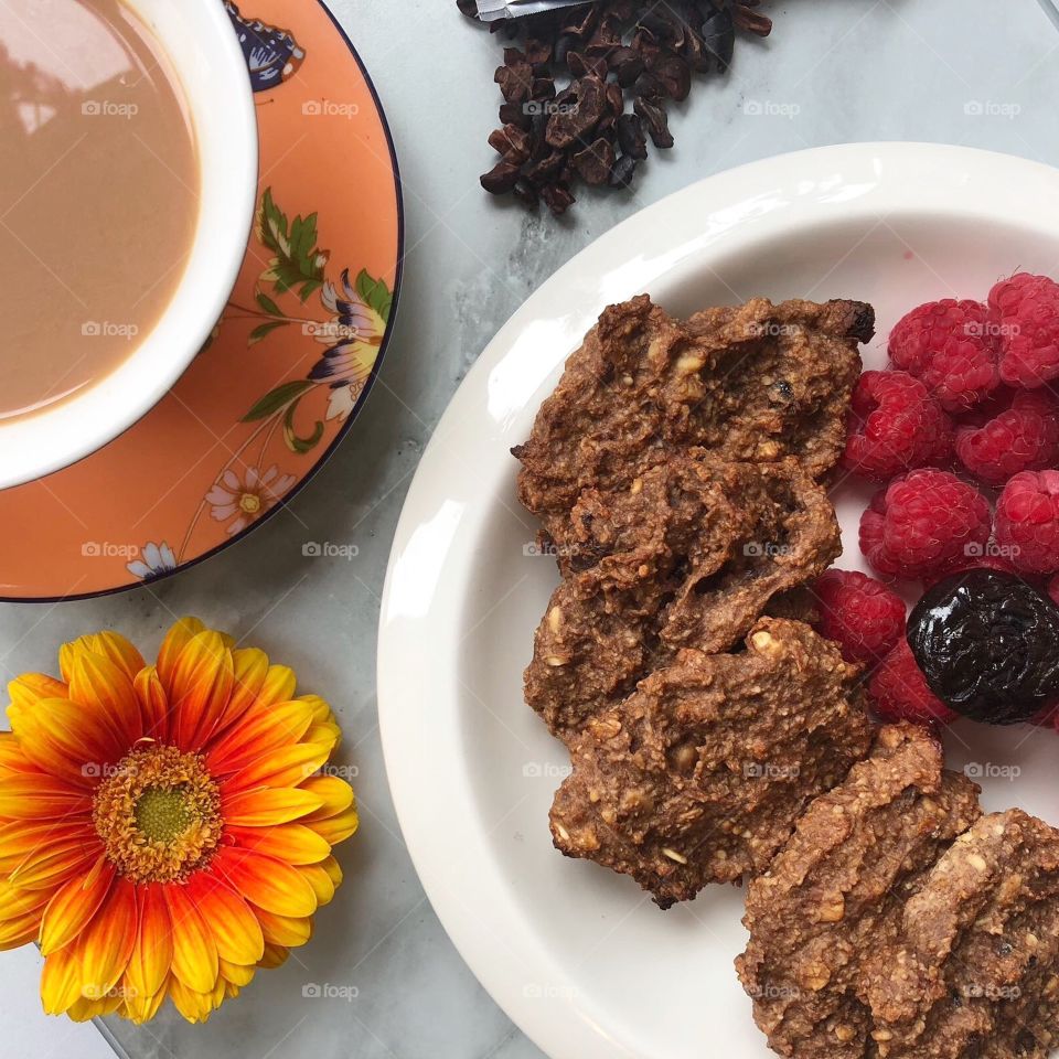 Homemade healthy oat cookies with tea cup and flower 