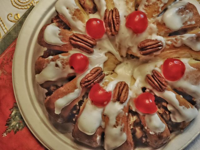 Frosted holiday tea ring with walnuts and candied cherries
