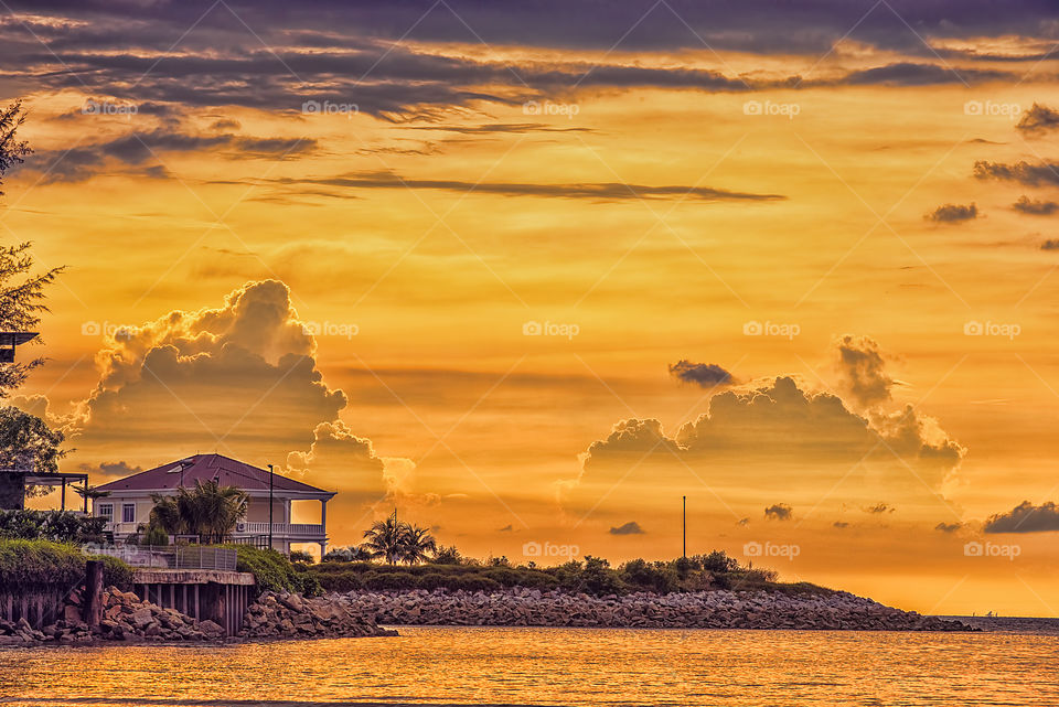 View of house on shore at sunset