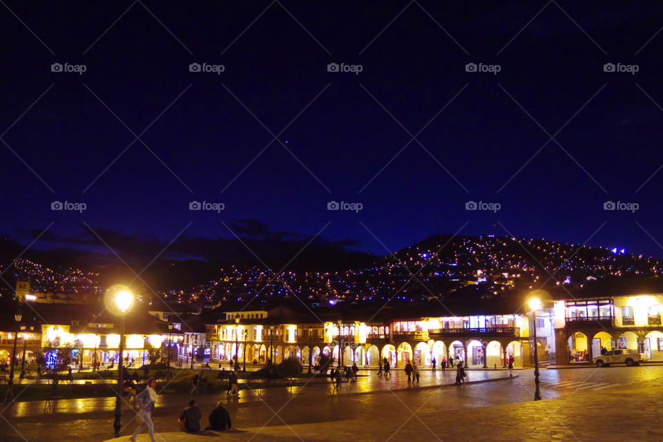 Illuminated Plaza de Armas and surrounding hills in Cusco, Peru