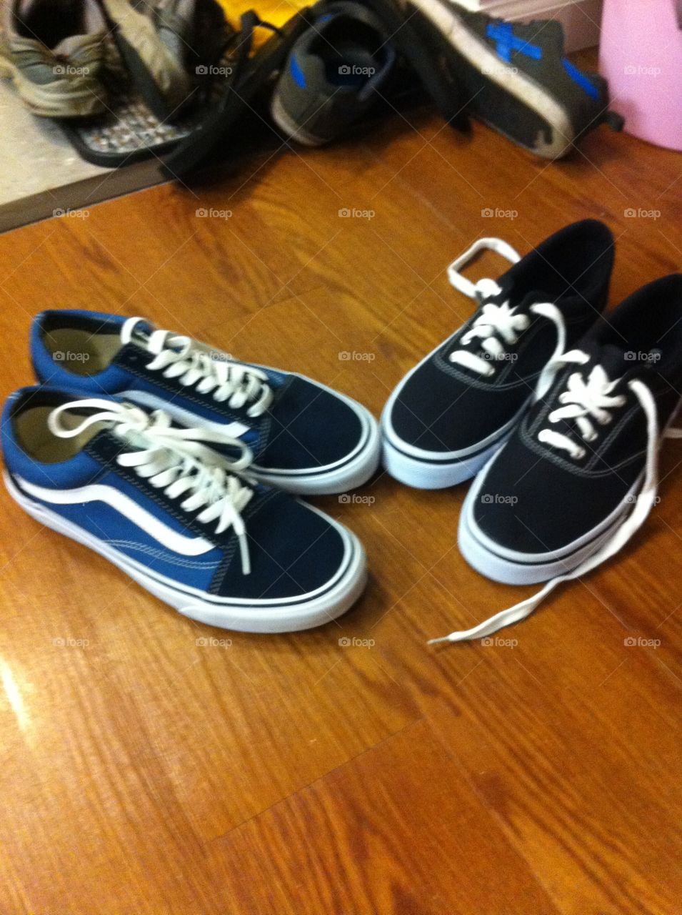 Two pairs of Vans sneakers in blue and black