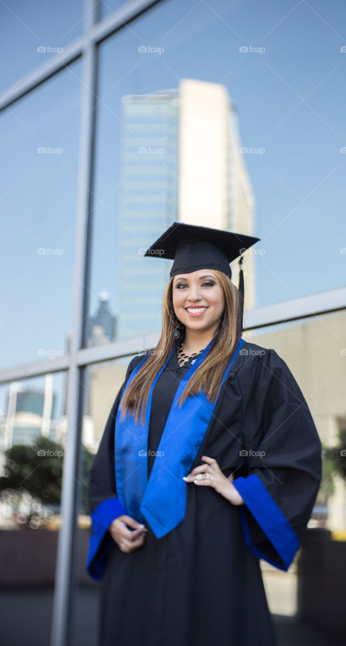 Happy graduate woman posing