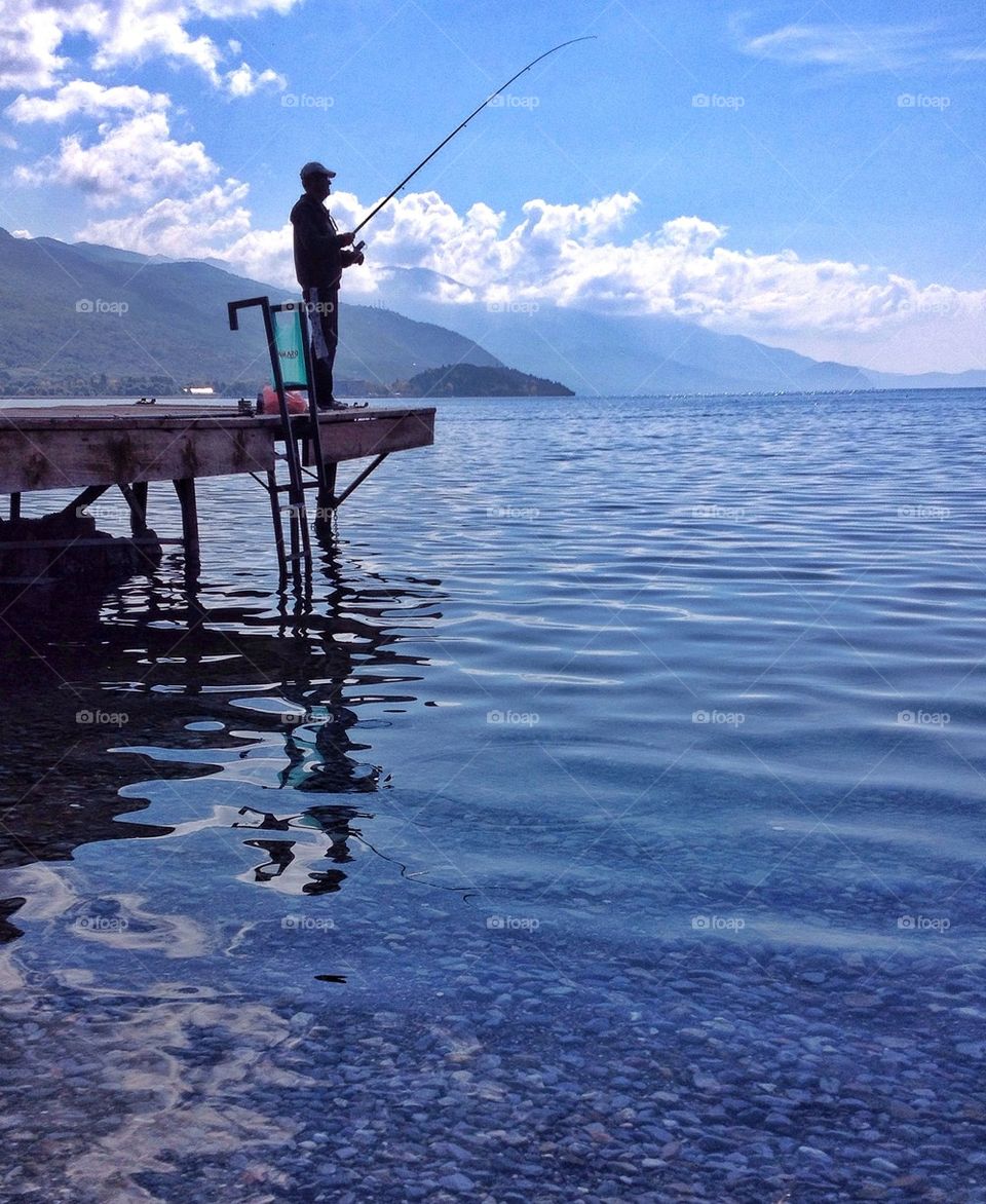 A reflection of a fisherman