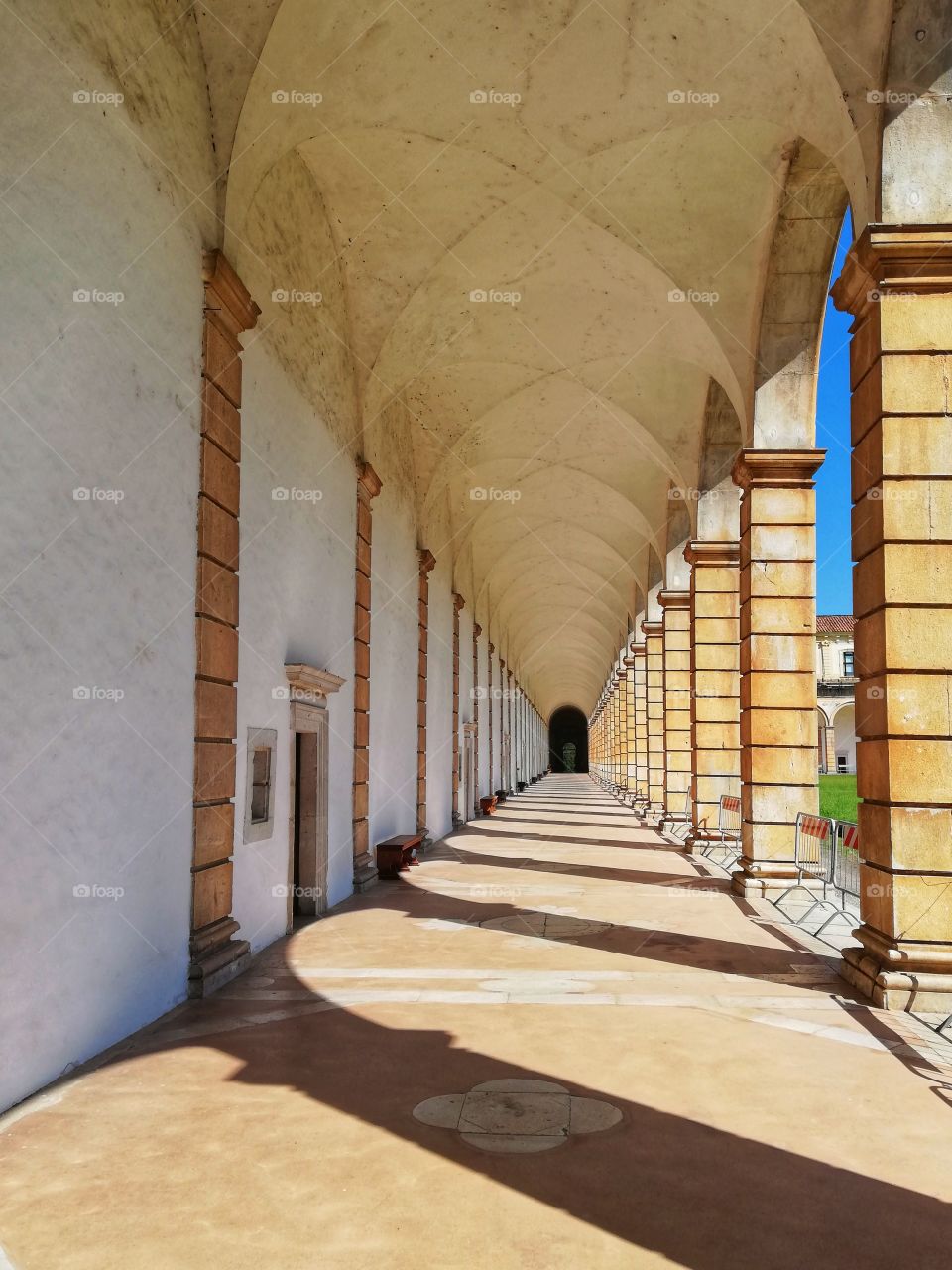 Shadows of the colonnade of the Certosa di San Lorenzo building in Italy