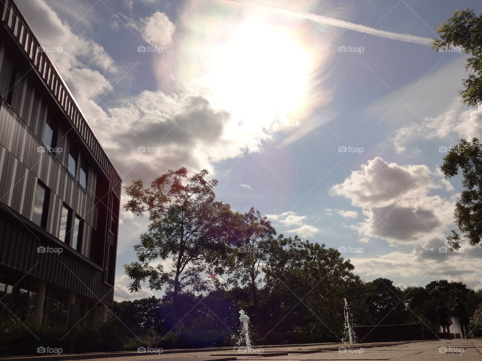 city landscape. rays of the burning sun  over fountains