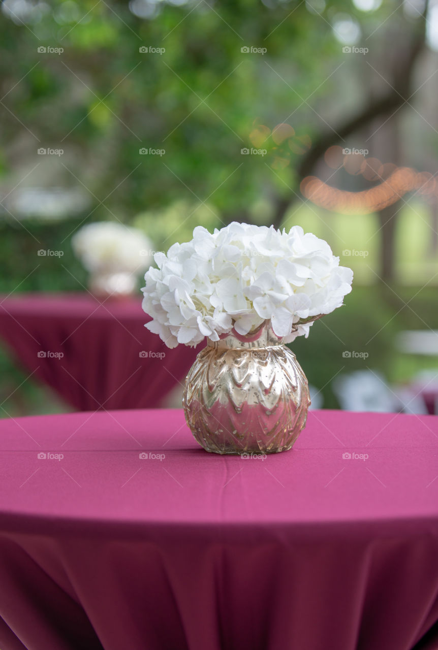 white hydrangea in gold round vase centerpiece