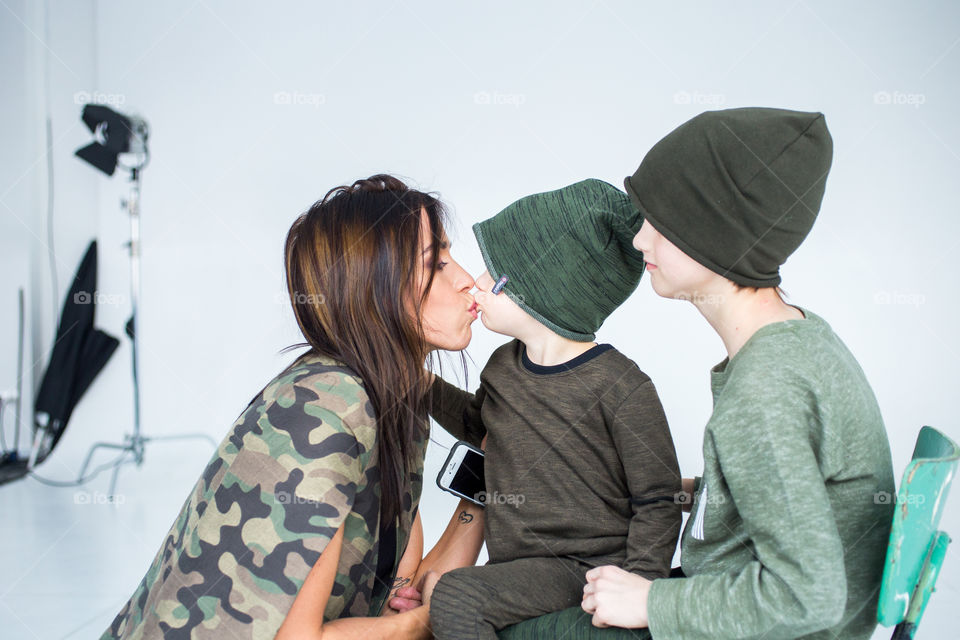 happy mom with her sons in harmony.  children kiss mom