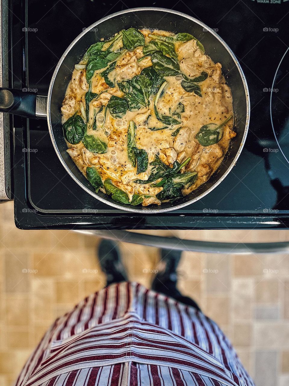 Cooking Tucson Chicken meal at the stove, woman makes dinner for her family, smartphone food photography, mobile food photography, mother wearing apron cooks dinner for family, standing at the stove cooking while wearing an apron, making dinner