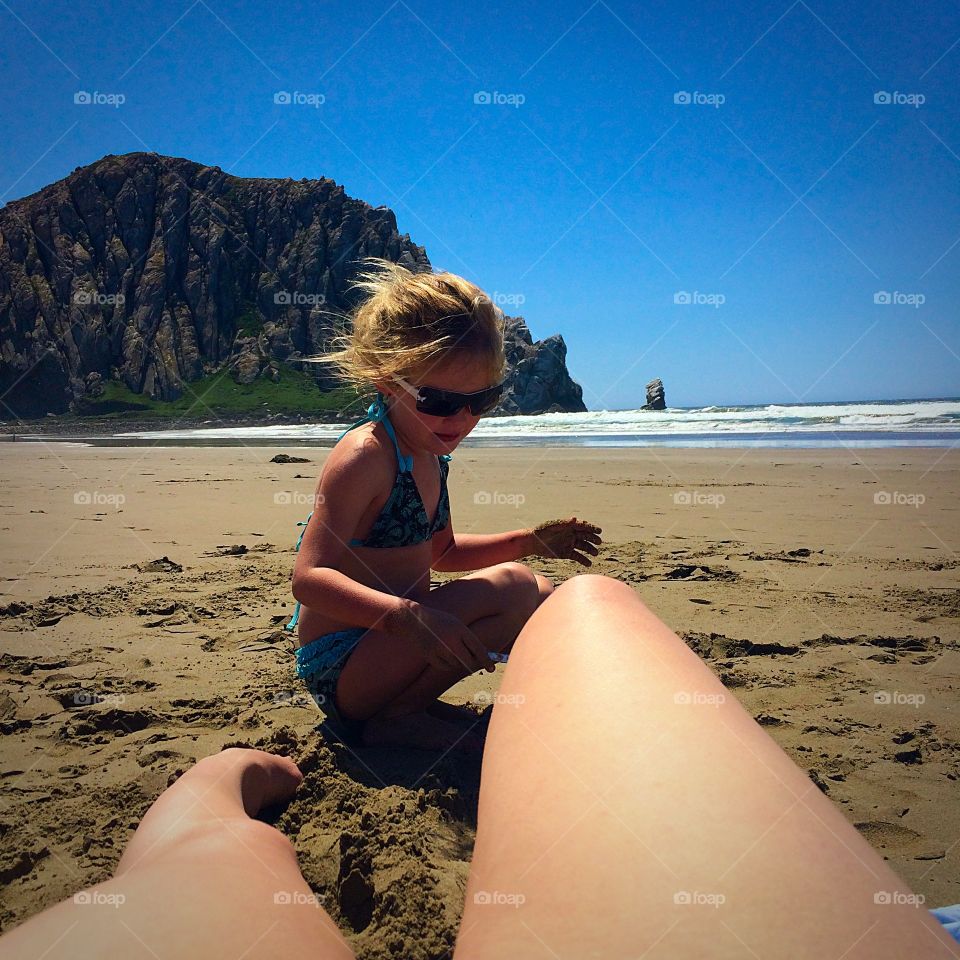 Beach babe. Morro Rock. Kid playing in the sand