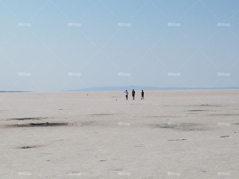 people in the distance in the middle of the salt lake of Sereflikochisar Turkey