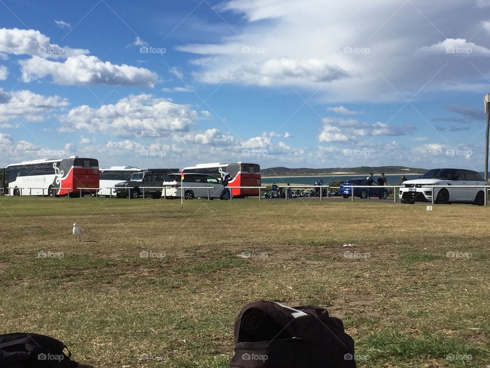 Car park with grass and clouds