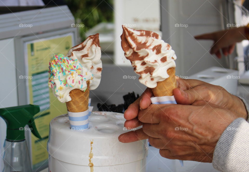 A triple ice cream by the foodtruck.