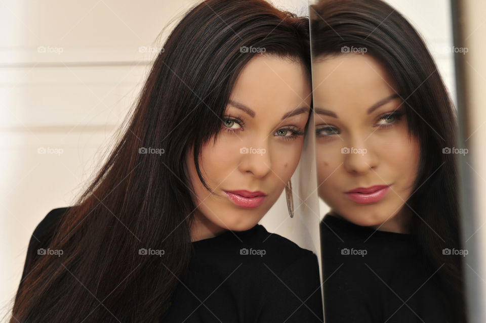 Reflection of a beautiful woman in mirror