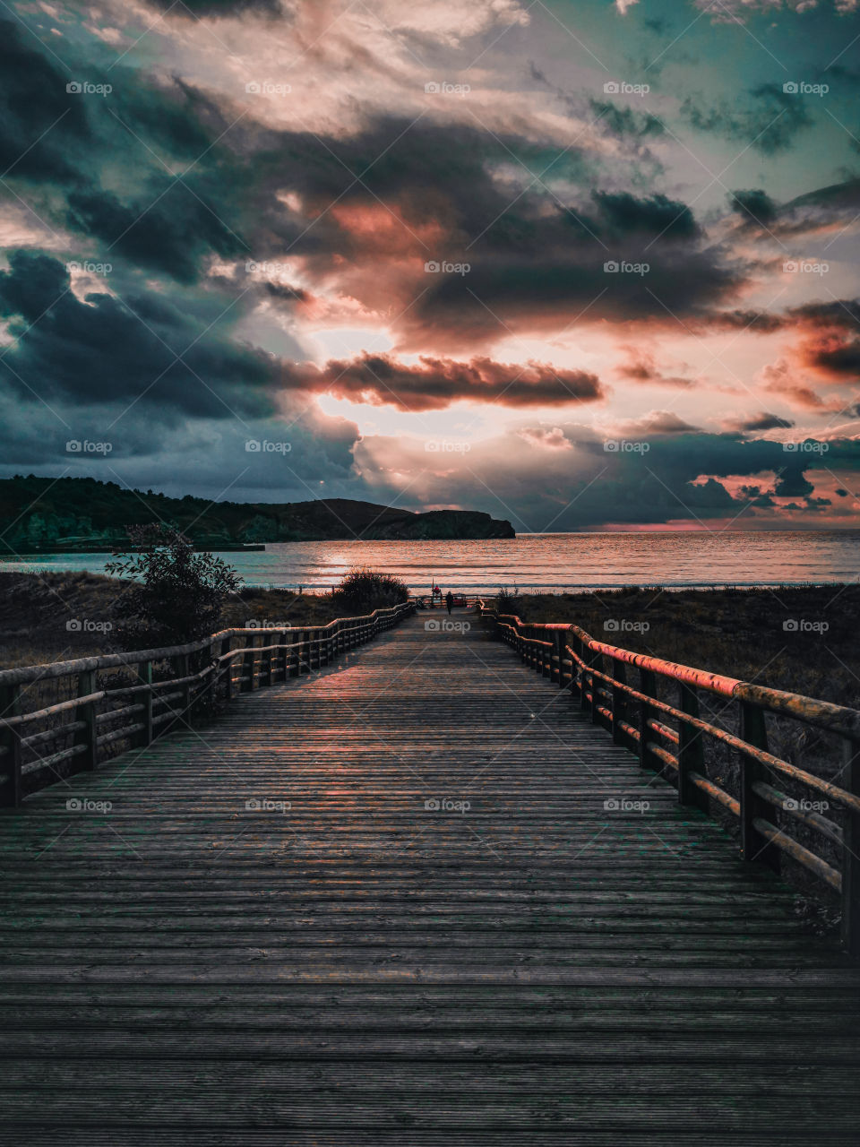 Wooden beach ramp and a sunset over the sea