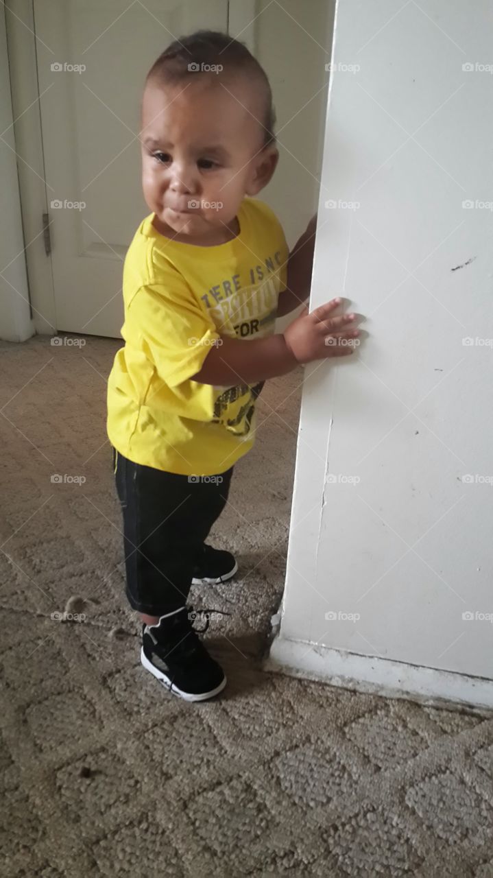 Baby is trying to walk. trying to walk but wont let go of the wall