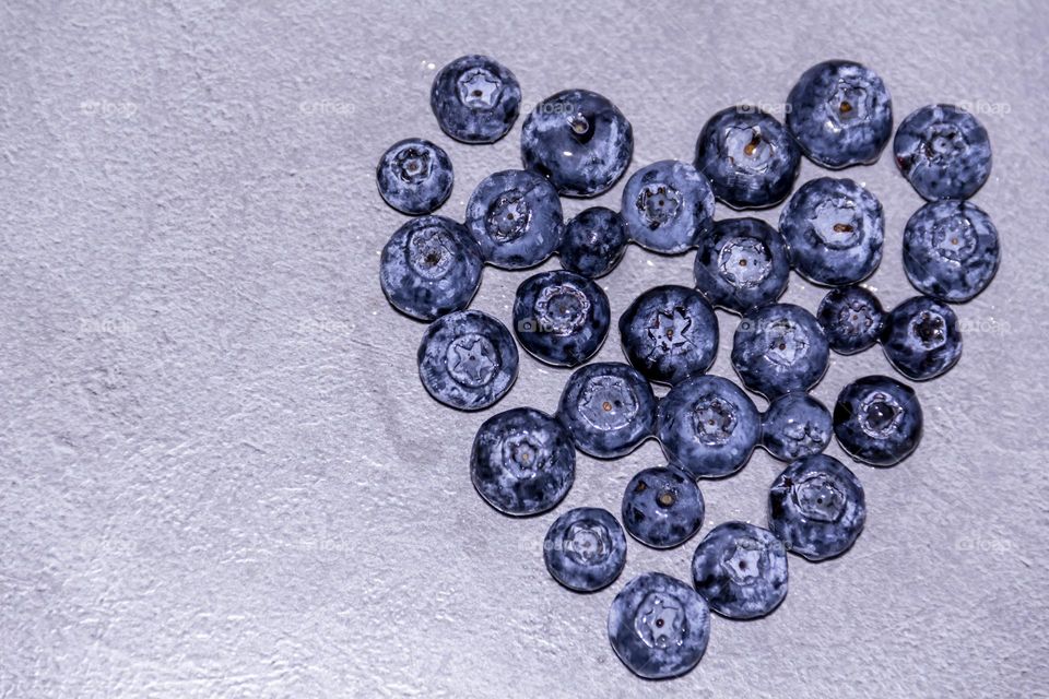 Fresh, fragrant, sweet and healthy blueberries in the shape of a heart.