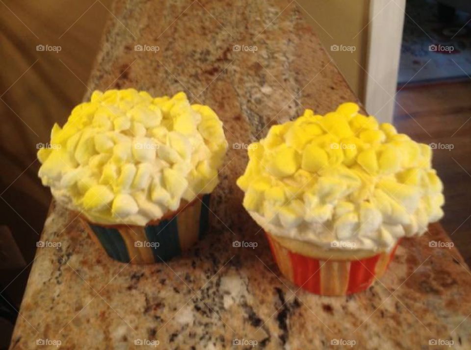 Carnival theme cupcakes with a popcorn looking topping made out of mini marshmallows.