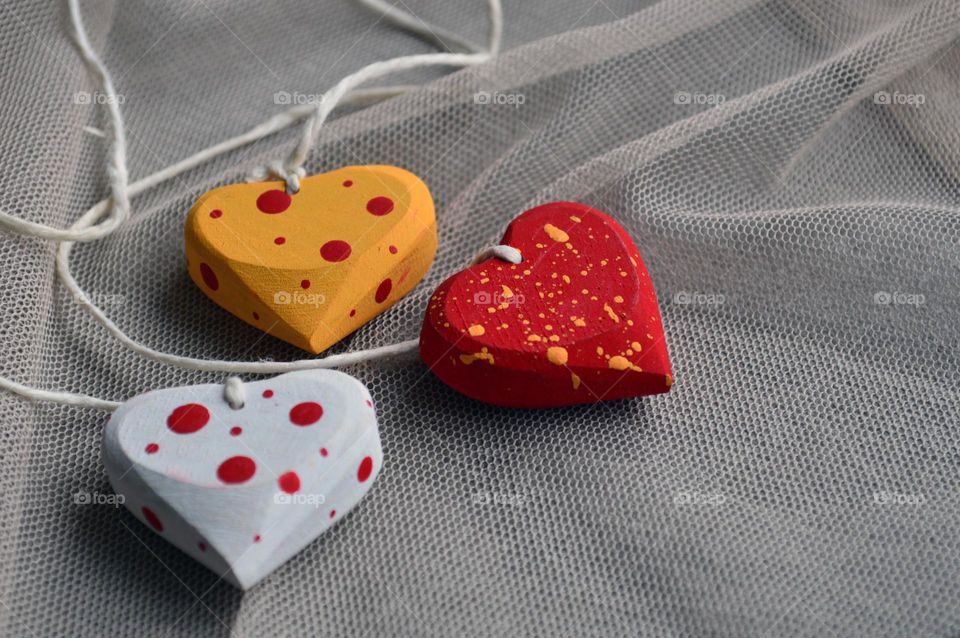 Multicolored wooden hearts on a thread