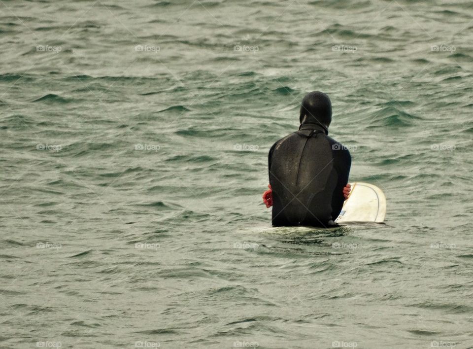 Surfer Waiting To Catch A Wave. Patiently Waiting