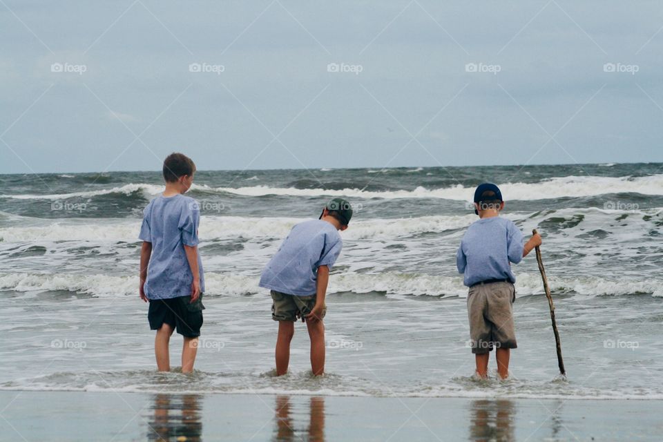 Little boys crabbing at the beach
