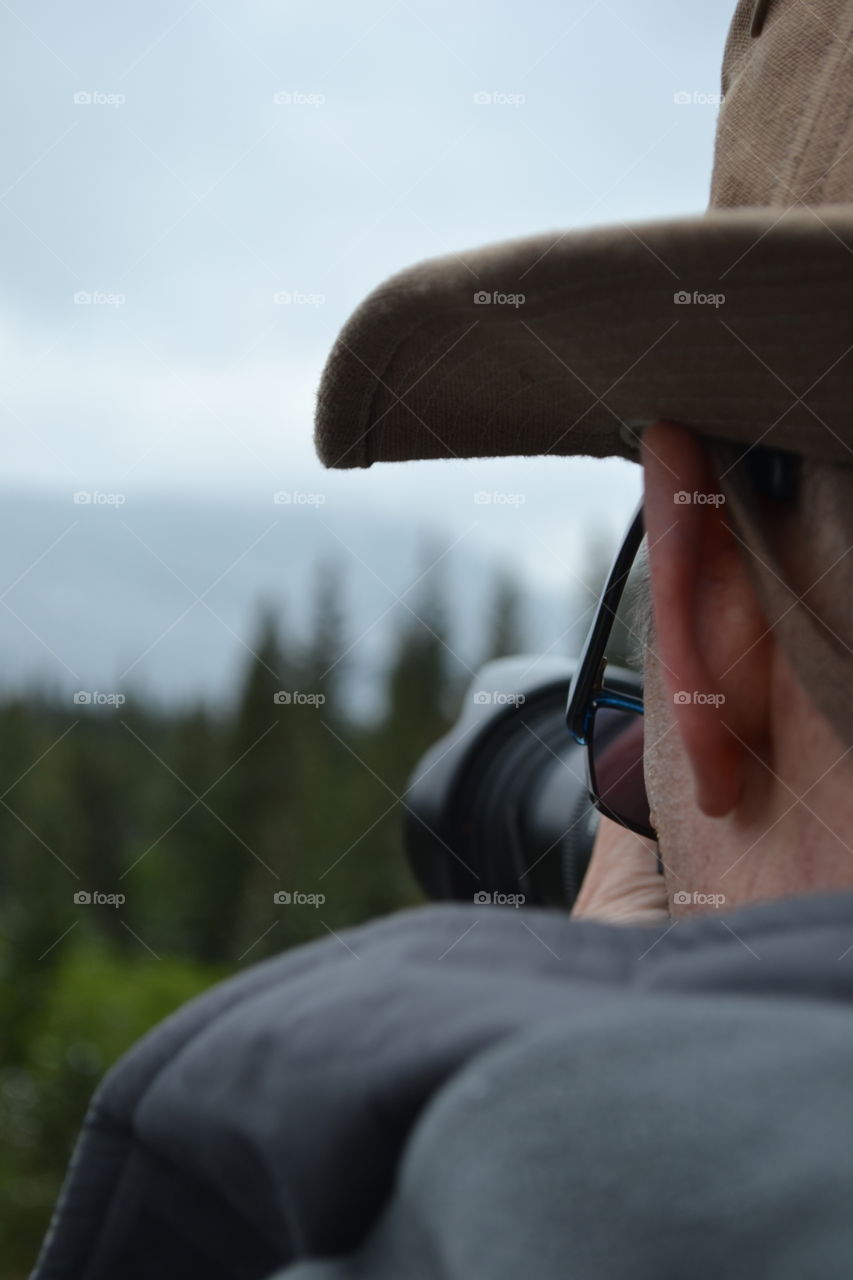 Male photographer closeup side ire head shot with camera