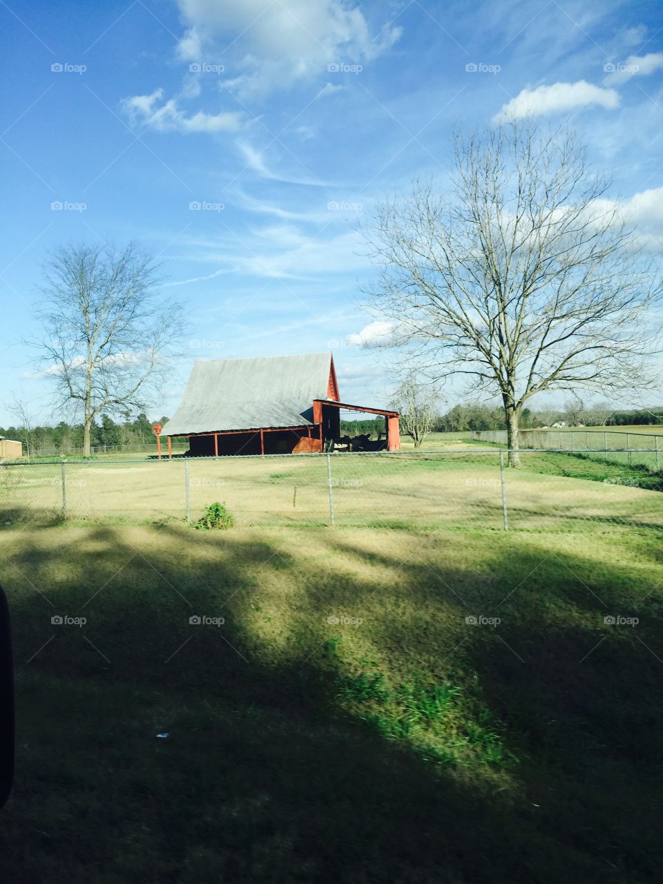 Barn in the field a field of green.