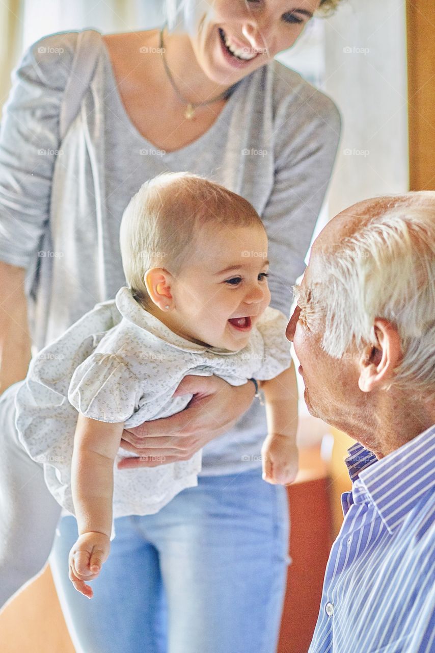 Small kid playing with grandfather