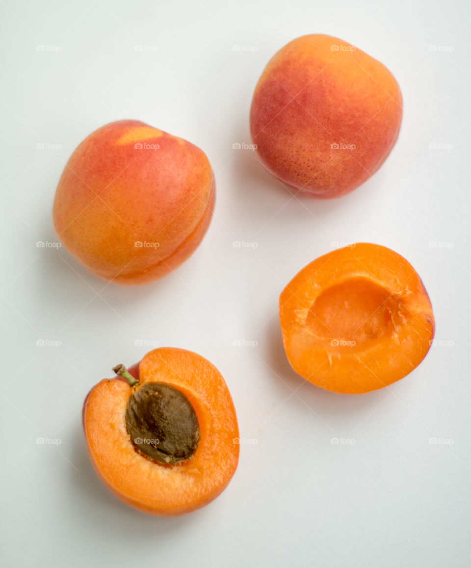 Fresh apricots on white background