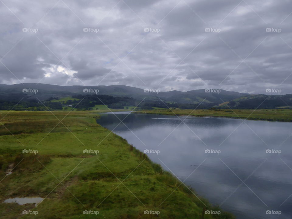 A btoad river near the sea and hills. Near Aberdovey