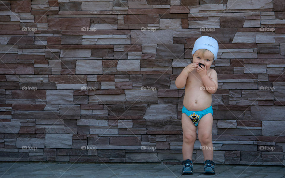 Portrait of a boy standing in front of wall