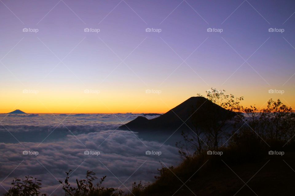 Panoramic view of Sea of clouds on colorful sunset in the mountains.