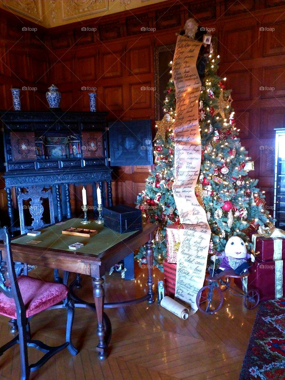inside the beautiful Biltmore Estate in Asheville NC. just one of the many trees that adorn the house during Christmas time. the toys around the trees are original toys given to the Vanderbilt children.