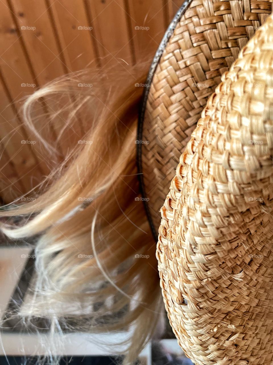 Straw sun hats on blond hair