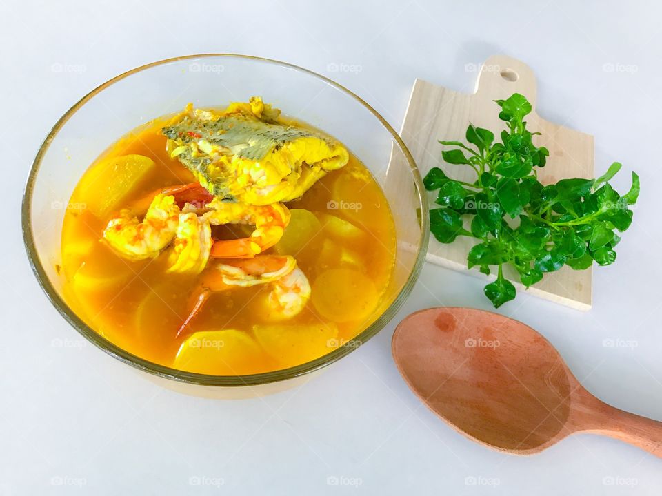 Shrimp and fish with sliced white radish in yellow sour and spicy soup from southern Thai cuisine