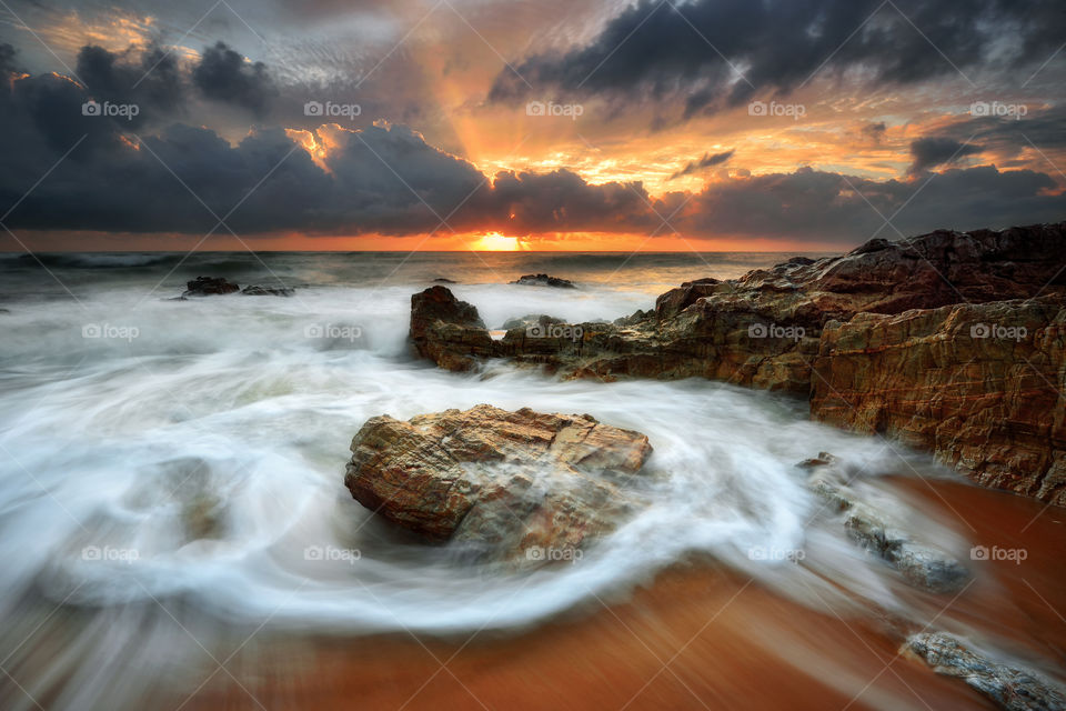 Dramatic sunrise with motion waves at Kemasik Beach, Terengganu